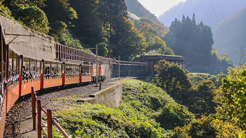 A shot of the Kurobe Gorge Railway parallel to the train line. The train is in view as the photo is being taken from one of the back cars.